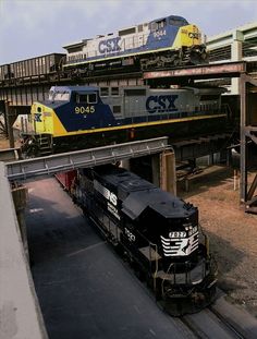 two trains are passing each other on the tracks