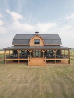 a large wooden house in the middle of a field