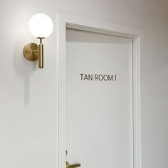 an open door with the word tan room on it and a light above it that says tan room