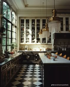 a kitchen with black and white checkered flooring, chandelier hanging from the ceiling