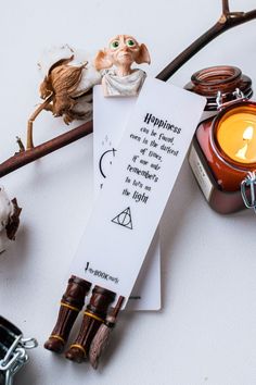 a bookmark sitting on top of a table next to some candles and other items