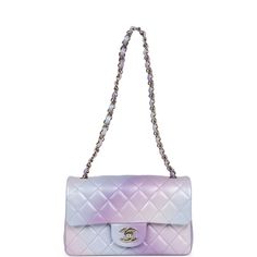 This Chanel mini classic rectangular flap bag is of ombre iridescent purple, pink and blue lambskin leather with light gold tone hardware and has a front flap with signature CC turnlock closure, rear half moon pocket, single interwoven ombre leather and light gold chain link shoulder/crossbody strap.The interior is lined in iridescent purple leather and features a zipper pocket with Chanel pull and an open pocket below.Collection: 24P (RFID)Origin: FranceCondition: New and never wornAccompanied by: Chanel box, Chanel dustbag, carebook, felt, retail UPC and RFIDMeasurements: 8" width x 5" depth x 2.5" height; 22.5" strap drop Light Purple Purse, Luxury Lavender Rectangular Bag, Lavender Chanel Bag, Chanel Mini Rectangular, Pink Iridescent Chanel Bag, Designer Purple Bags With Gold-tone Hardware, Pink Vibes