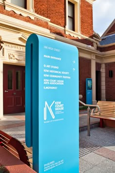 a blue sign sitting in front of a building