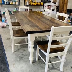 a table and chairs in a room with shelves