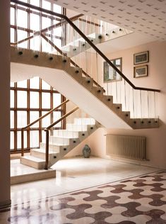 a stair case in an empty room next to a window