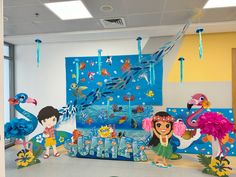 children's birthday party decorations in the shape of animals and mermaids on display