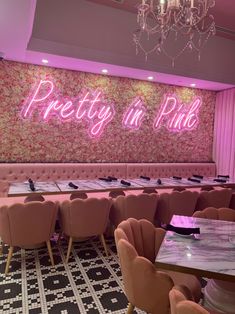 a restaurant with pink walls and chandeliers