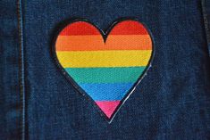 a rainbow heart patch in the back pocket of a pair of jeans