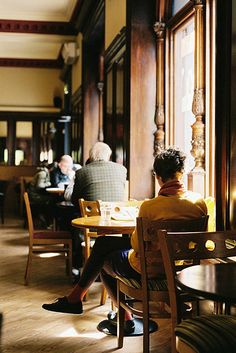 a woman sitting at a table in a restaurant