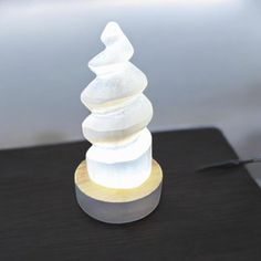 a white light sitting on top of a wooden table