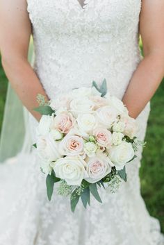 the bride is holding her wedding bouquet