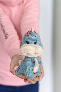 a person holding a small stuffed animal in their hands