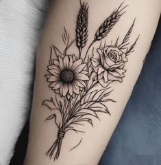 a black and white flower tattoo on the right arm, with wheat stalks in the foreground