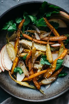 a bowl filled with carrots and other vegetables