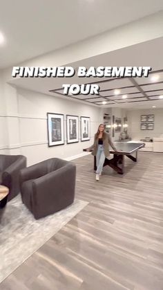 the finished basement tour is taking place in an empty room with two couches and a ping pong table