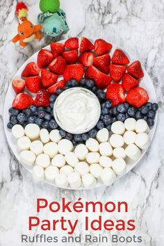 a plate with strawberries, blueberries and marshmallows on it