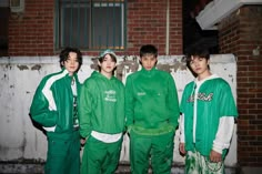 four young men in green sweat suits standing next to each other