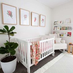 a baby's room with white furniture and pictures on the wall, including a crib