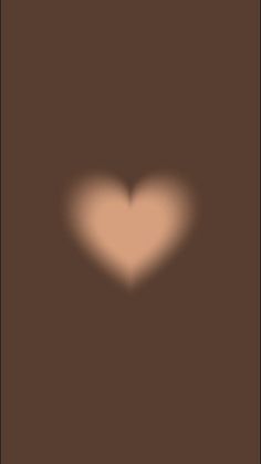 a heart shaped shadow on a brown background