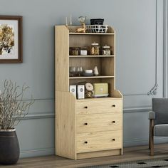 a living room with a bookcase and chair next to the wall in front of it