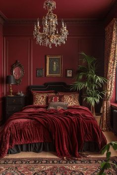 a bedroom with red walls and a chandelier hanging from the ceiling