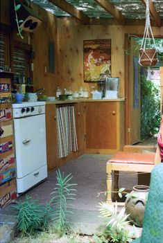 a kitchen filled with lots of pots and pans next to a stove top oven