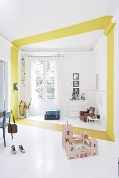 a living room filled with furniture and yellow walls