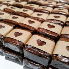 many brownies are wrapped in brown paper with hearts on them