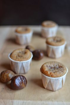 several muffins and some nuts on a table