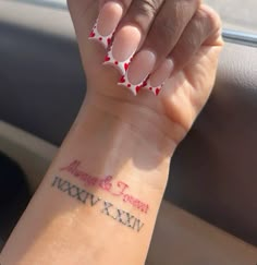 a woman's arm with red and white polka dots on it that says miss you