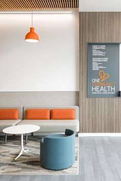 an office waiting area with couches and tables