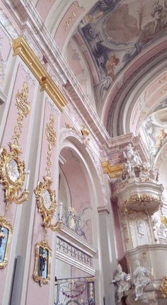 an ornately decorated room with gold and white decorations on the ceiling, along with other decorative items