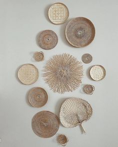 a group of wicker plates sitting on top of a white table