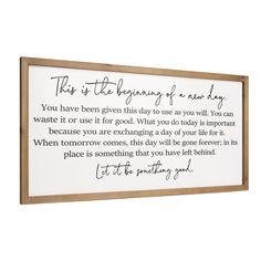 a wooden framed sign that says,'this is the beginning of a new day '