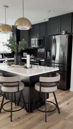 a kitchen with black cabinets and white counter tops