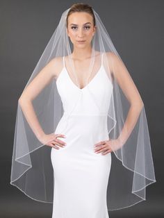 a woman wearing a wedding veil and dress