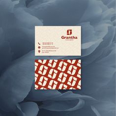 two business cards on top of each other with an image of flowers in the background