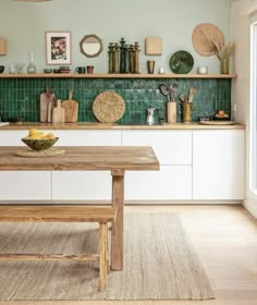 a wooden table sitting in the middle of a kitchen