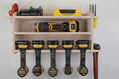 a shelf filled with lots of tools on top of a wooden shelf next to a hammer