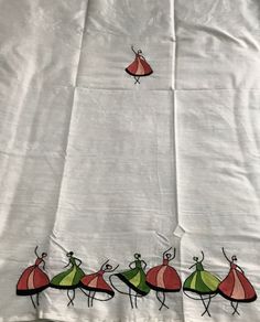 an embroidered sheet with four different colored dresses on it and a small red bird flying over the top