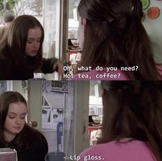 two women in pink shirts talking to each other and one is holding a coffee cup