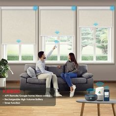 two people sitting on a couch in front of windows with wifi connected to the ceiling