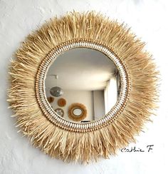 a mirror that is on the wall with some kind of thing in front of it