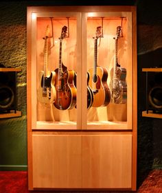 a display case with guitars in it