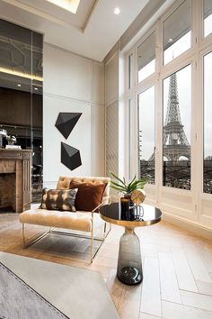 a living room filled with furniture and a fire place in front of a large window