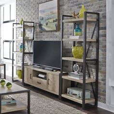 a living room filled with furniture and a flat screen tv on top of a wooden shelf