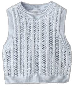 a white knitted sweater with an openwork pattern on the chest and shoulders,