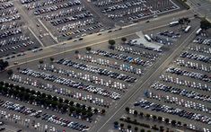 an aerial view of a parking lot full of cars