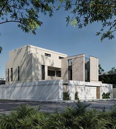 a large white building sitting next to a lush green forest