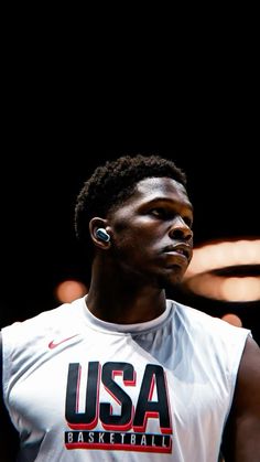 a basketball player with ear buds in his ears